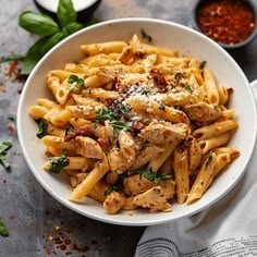 Creamy marry me chicken pasta with sun-dried tomatoes, Parmesan sauce, and fresh basil on a plate